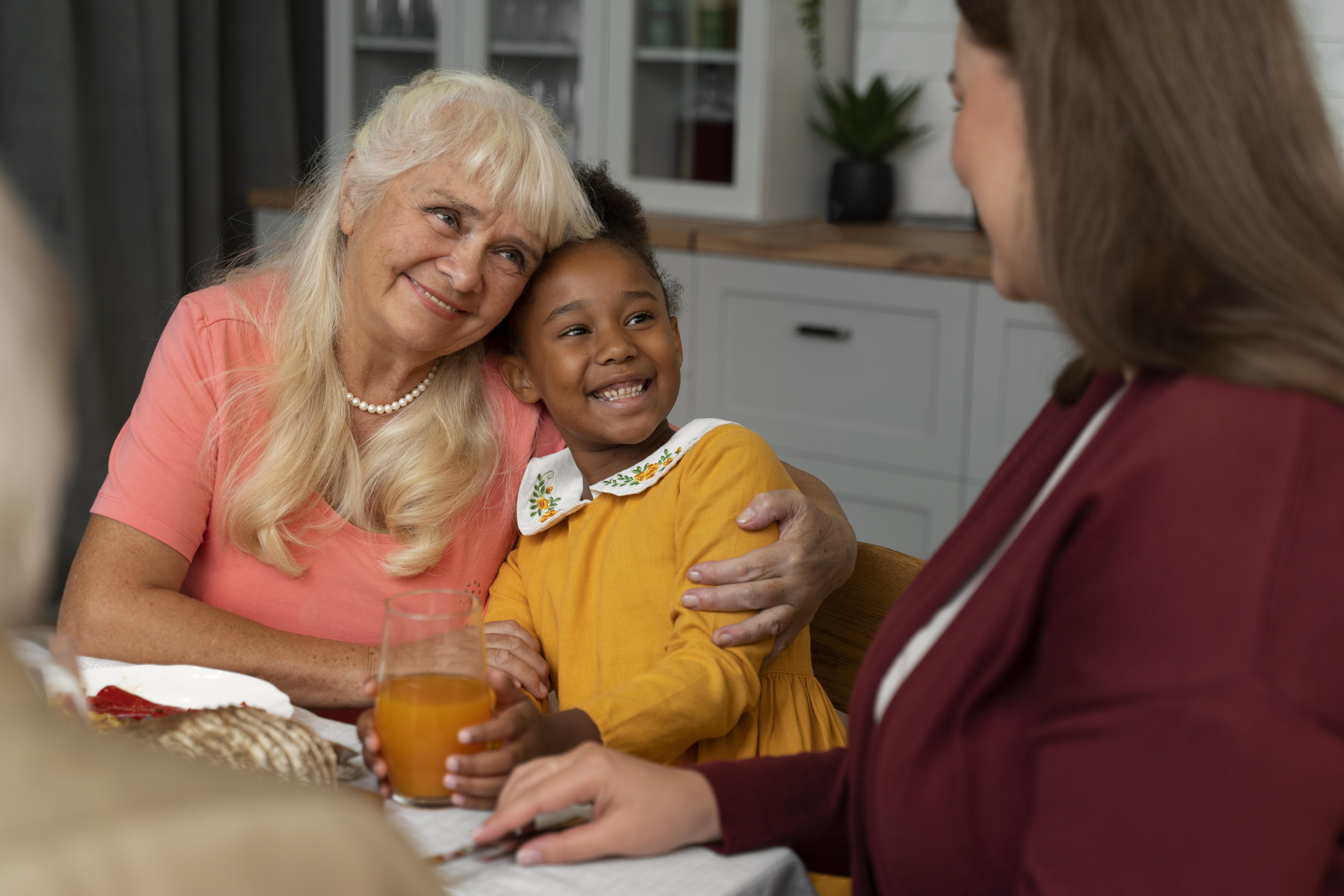 Adult child talking with an older parent at home